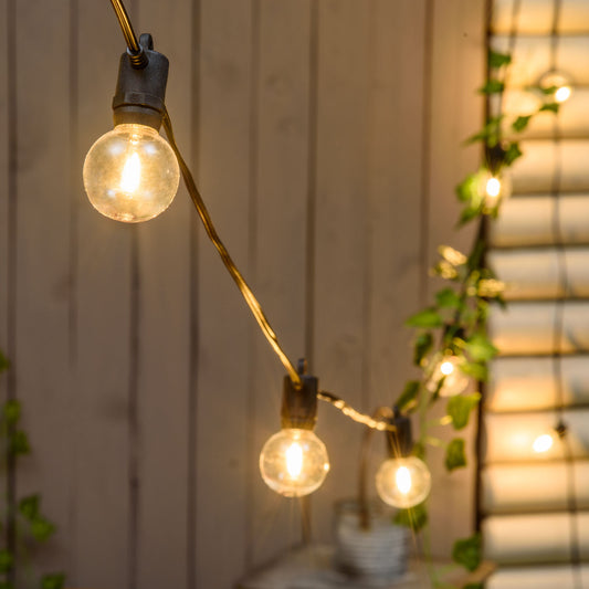 Festoon lights elegantly strung across an outdoor patio, providing a warm and inviting glow for evening gatherings. These outdoor festoon lights are perfect for decorating gardens, backyards, or special events, enhancing any outdoor space with charm and functionality